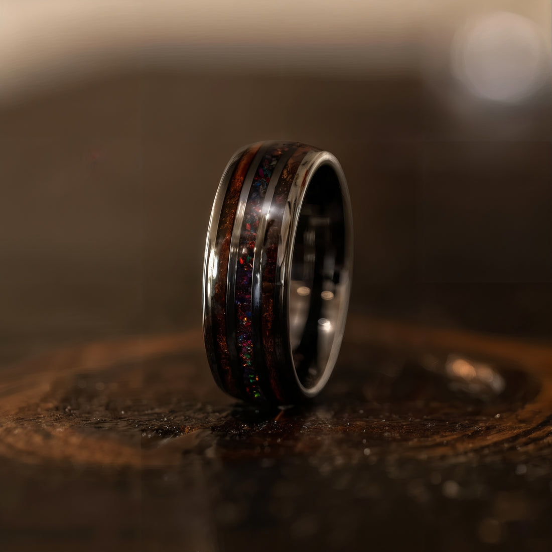 Whisky Barrel Wood and Opal Inlay Ring Displayed on a Rustic Surface