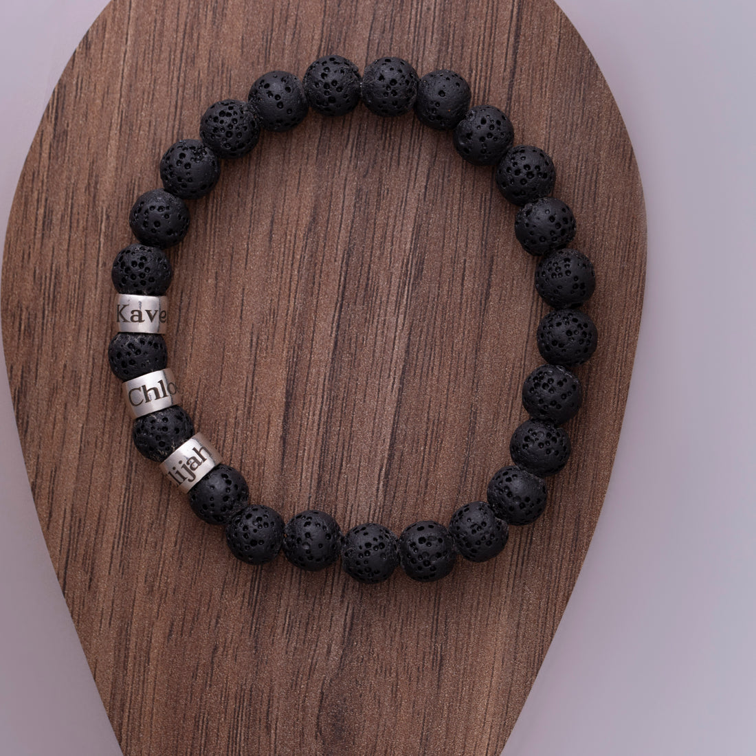 Durable men's bracelet made from lava rock, featuring names of family members, embodying the spirit of courage and family bonds, great for everyday wear.