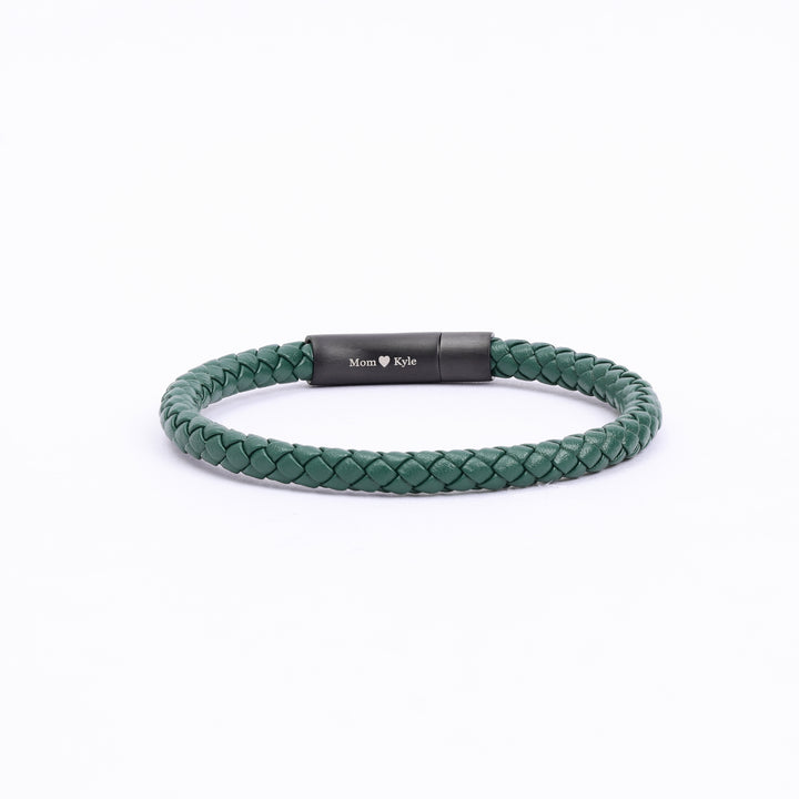 Personalized green leather braided bracelet with an option for personal engraving on the clasp, designed for both men and women, presented on a simple background."