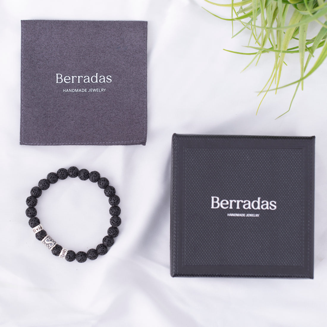 A men's bracelet made of lava beads with an infinity charm in the center and a customizable name plate, symbolizing eternal love – perfect for Valentine's Day