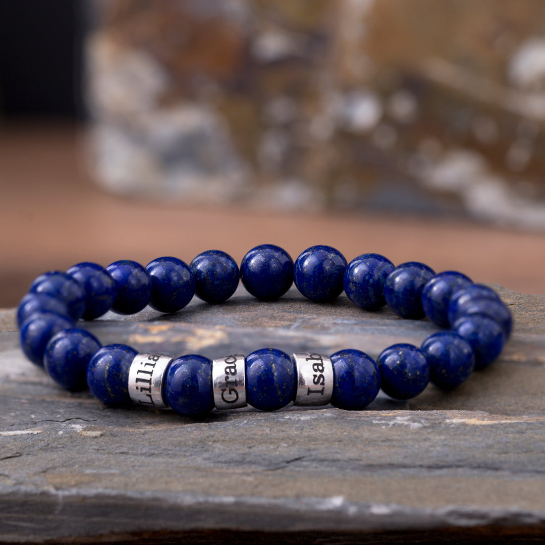 Lapis lazuli bracelet featuring engraved family names, a custom jewelry piece for dads and husbands
