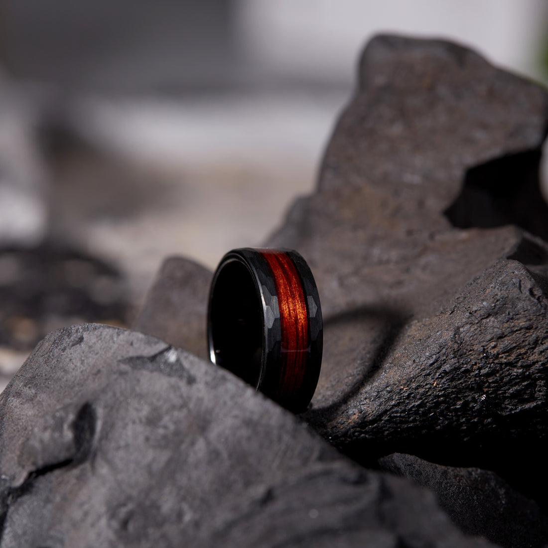 Men's stylish 8mm black hammered ring made of tungsten and featuring a natural walnut wood inlay