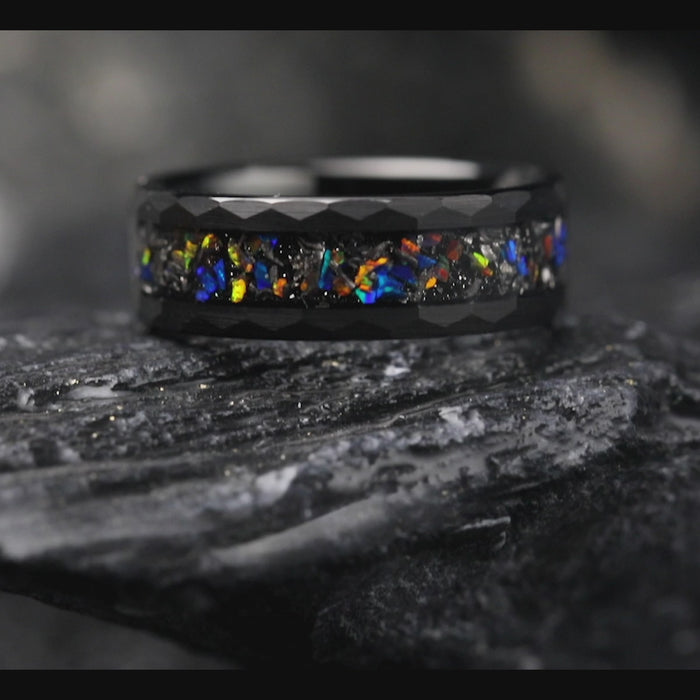 Bold men's ring with a sleek black band and striking opal gemstones.